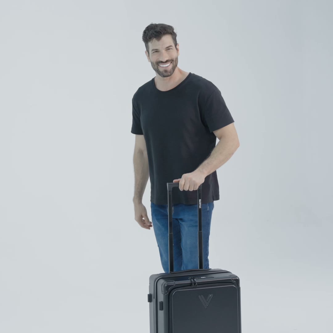 Man rolling the Backvac Flight Carry-on