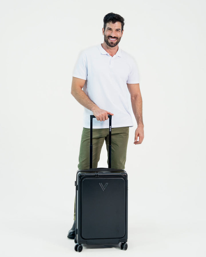 Male model, 6 ft, standing with the Backvac Flight Carry-on