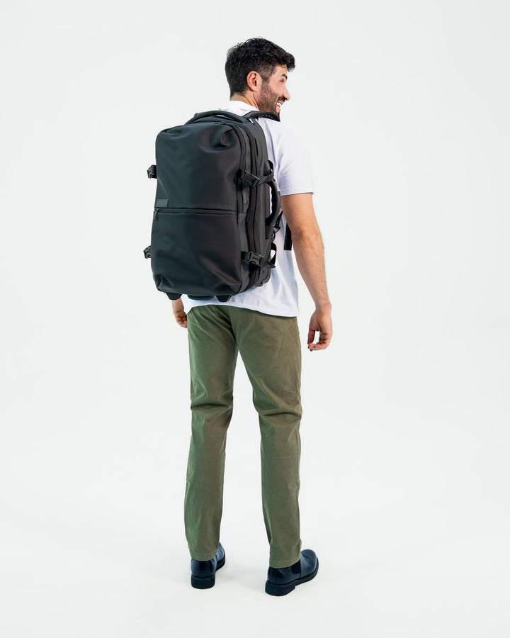 Male model, 6 ft, wearing the Backvac Pro Max as a backpack, seen from behind